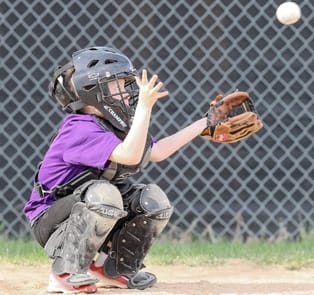 "Con el ojo en la bola, el cátcher de 'The Twin Metals Rockies' de la Liga Infantil de Ely", dice el periódico local "Con el ojo en la bola, el cátcher de 'The Twin Metals Rockies' de la Liga Infantil de Ely", dice el periódico local.