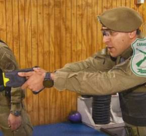 De fondo, la demostración que Carabineros dio a C13 por el uso de pistolas taser De fondo, la demostración que Carabineros dio a C13 por el uso de pistolas taser